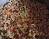 A picture of step 7 of Jollof macaroni with fried boneless fish.