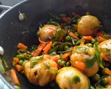 A picture of step 13 of Stuffed Riceballs tossed in mix vegetables.