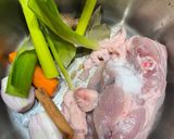 A picture of step 1 of Cook every part - Chicken broth (with some meat) from chicken back/carcass, and wing tips.