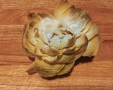 A picture of step 4 of Grilled Artichokes with Garlic, Oil, and Parsley Dressing.