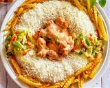 A picture of step 8 of Saucy Crispy chicken with rice fries and vegetable.
