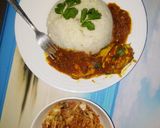 A picture of step 5 of Egg curry served with white rice and sauted cabbage.