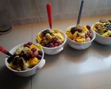 A picture of step 4 of #endyearchallenge mixed fruit salaad different nuts.