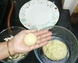 A picture of step 5 of Aloo kofta with paneer stuffing in golden gravy.