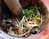 A picture of step 2 of Som Tum (Papaya Salad with Pickled Crab and Fermented Fish Sauce).