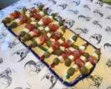 A picture of step 7 of Appetizer Skewers with Green Olives, Tomato, Prosciutto, and Pyrenees Cheese.