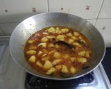 A picture of step 2 of Gujarati lunch (rasadar aloo sabji, amrakhand, puri, dal, rice).