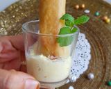 A picture of step 10 of Moong Dal Halwa Cigars dipped in Shaahi Rabdi.