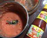 A picture of step 2 of Chatpata Bread Upma in red sauce.