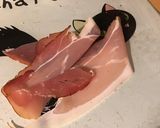 A picture of step 2 of Ham, Olive, Anchovy, and Tomato 'Eye' Canapés.