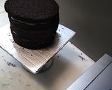 A picture of step 2 of 8 inch tall chocolate brownie cake.