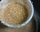 A picture of step 1 of Moong dal dalia broken weat.