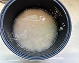A picture of step 1 of Choco Biko with white coconut shreds and toasted coconut.