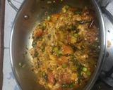 A picture of step 5 of Baingan bharta with green peas.