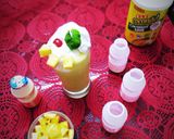 A picture of step 7 of Virgin Yakult Pina Colada topped with Whipped Cream.