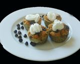 A picture of step 8 of COCONUT MUFFINS with blue berries and chocolate chips.