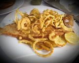 A picture of step 6 of Fried European Sole on a Bed of Potatoes and Garlic with Onion Rings.