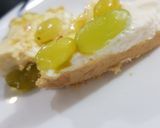 A picture of step 5 of 3 layered Cadbury and kiwi grapes Cheese cake 2 in 1.