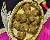 A picture of step 7 of Wheat flour seeds and nuts Ladoo with leftover ghee residue.