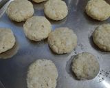A picture of step 3 of Coconut fritters deep in sugar syrup.