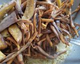 A picture of step 6 of Banana flowers dip in mustard seeds.
