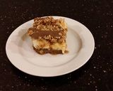 A picture of step 21 of Caramel Coconut Cheesecake Bars.