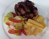 A picture of step 4 of Medium-well done steak having red sauce, French fries and salad.