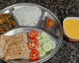 A picture of step 6 of Simiple veg thali lunch with bhindi roti rice mango juice.