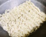 A picture of step 1 of Chicken schezwan Maggi noodles and tossed boiled egg with Maggi seasoning.