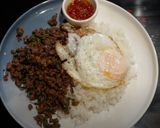 A picture of step 6 of My version of Thai Basil Beef (Pad Ka Prao) with dried chillies, topped with fried eggs.