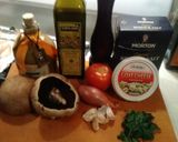 A picture of step 1 of Stuffed Portobello Mushrooms With oven roasted tomatoes.