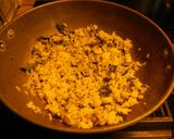 A picture of step 4 of Fried rice topped with green veggies.