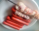 A picture of step 2 of Deep-Fried, Bacon-Wrapped Hot Dogs on Skewers.