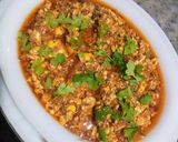 A picture of step 9 of Brain Masalah with tomatoes.