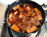 A picture of step 6 of Japanese style pork & tofu nimono.