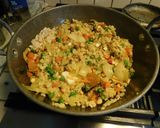 A picture of step 3 of Upma with puffed rice and colorful veggies.
