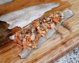 Foto del paso 6 de la receta: Lubina rellena de langostinos y panceta en salsa verde