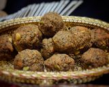 A picture of step 8 of Wheat flour seeds and nuts Ladoo with leftover ghee residue.