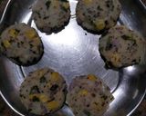 A picture of step 5 of Dhokla in idli version stuffed with cheezee rice patty.