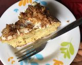 A picture of step 8 of Coconut cake topped with caramelized coconut flakes.