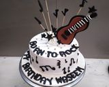 A picture of step 5 of Birthday cake music theme top on fondant guitar 🎸🎸🎸.