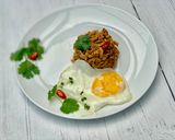 A picture of step 4 of Thai style egg noodles stir-fry served with fried egg.