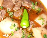 A picture of step 7 of Aloo Gosht.