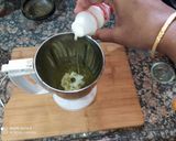 A picture of step 3 of Banana Moringa Yakult Milkshake topped with Walnuts.