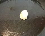 A picture of step 2 of Pan fried salmon on an open jacket with dill and butter.