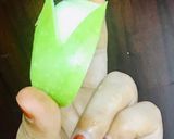 A picture of step 2 of Bunny- shaped green apple wedges.
