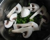 A picture of step 2 of Sarson ka sag with green pease & mushroom.