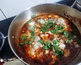 A picture of step 10 of Shakshuka with warm garlic bread (poached eggs in spicy sauces).