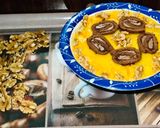 A picture of step 3 of Swiss roll mangoes custard loaded with walnuts.