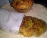 A picture of step 7 of Spinach kathi roll in fishbone wrap with red souce pasta.